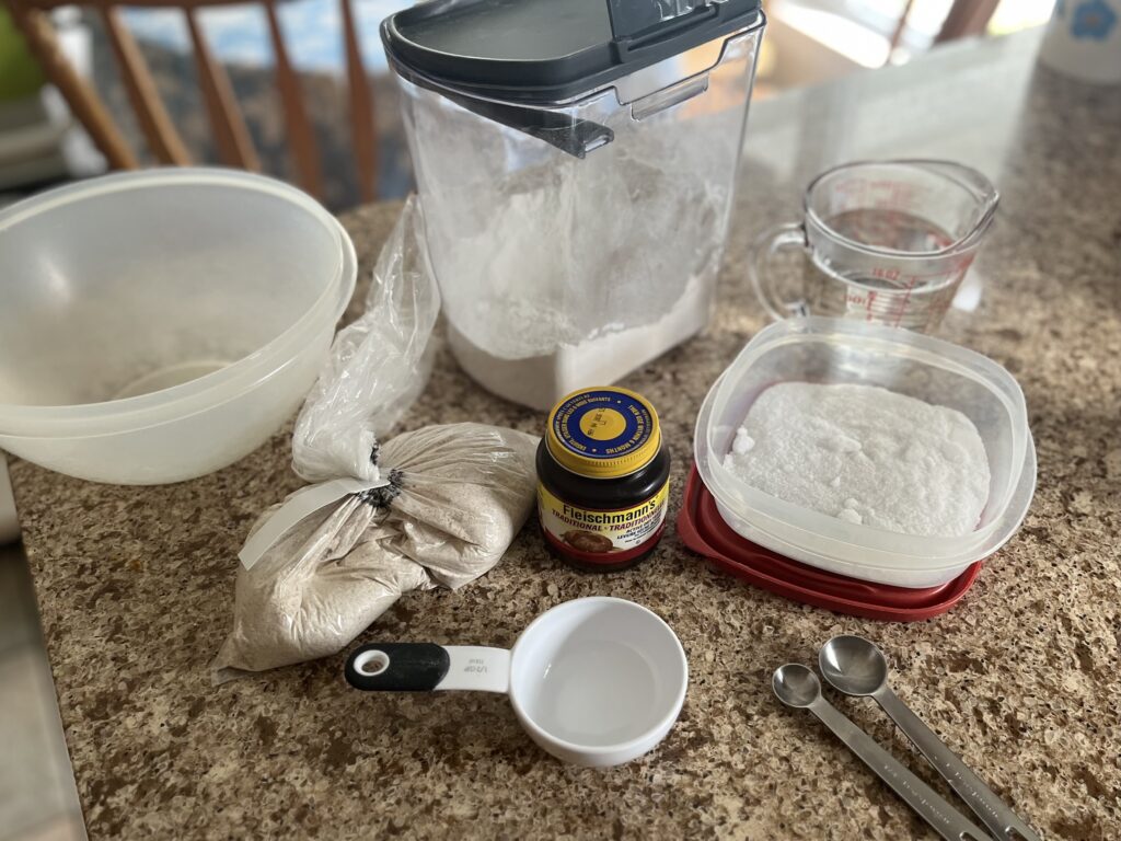 The ingredients for the bread recipe are laid out on a counter.