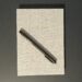 A closed notebook labeled "Bullet Journal" with a felt tip pen sitting on top.