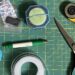 Close-up of a self-healing mat covered with various sewing tools mentioned in this post.