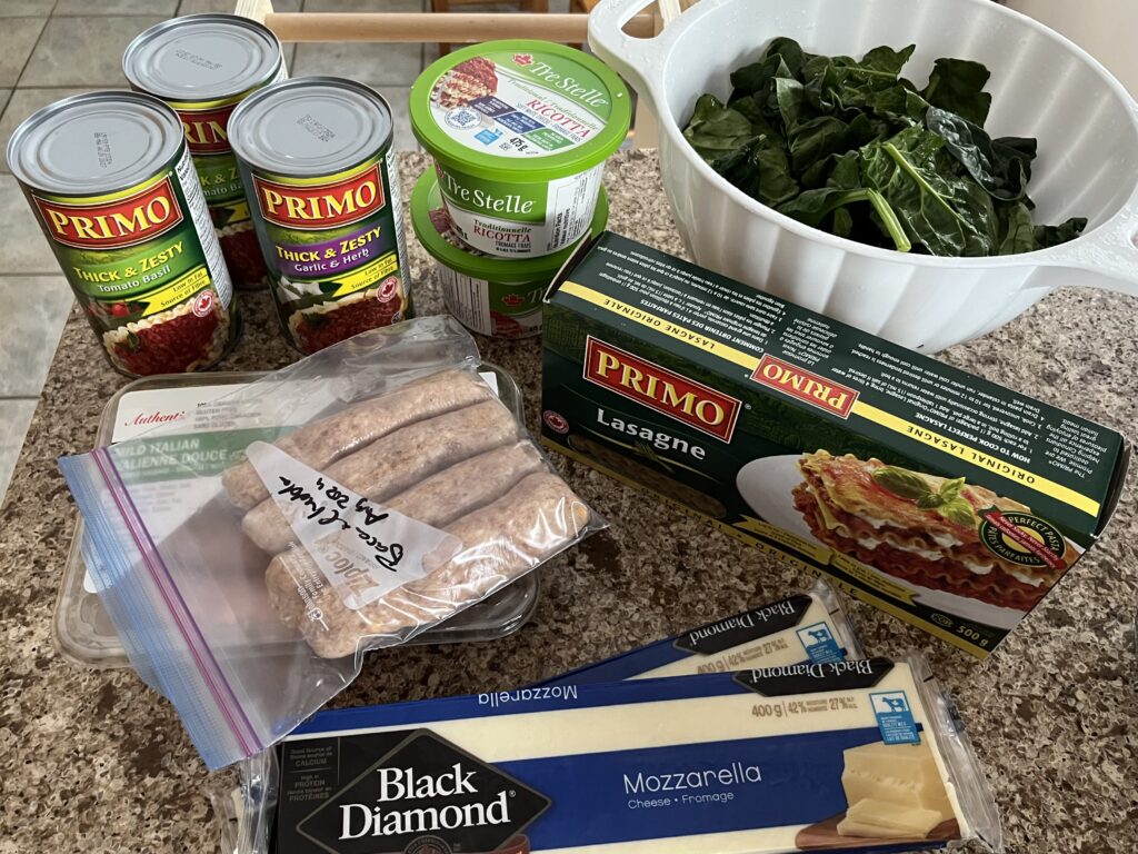 All of the ingredients for the lasagne recipe sitting on a countertop.