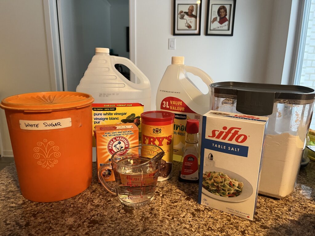All the ingredients for the chocolate cake recipe are displayed on a countertop.