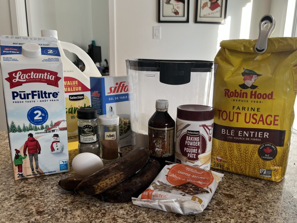 All the ingredients for the muffin recipe are laid out on a countertop.