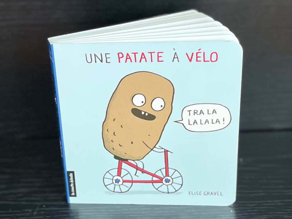 Close-up of the French-language board book Une patate à vélo